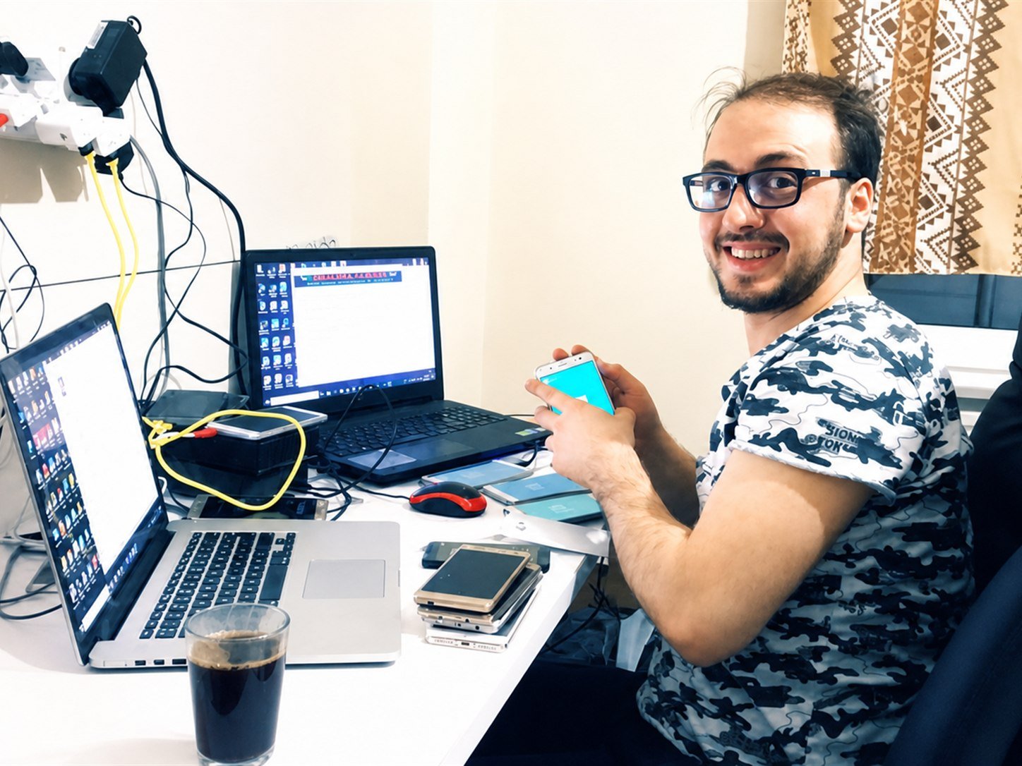Basel building late at his home desk, over a phone and two laptops.
