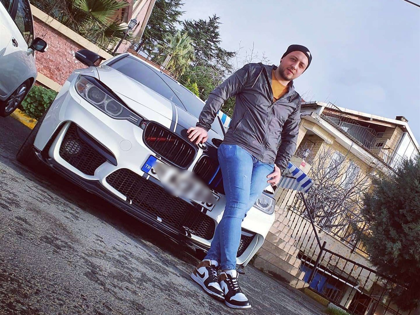 A striped white BMW in a tuning showroom.
